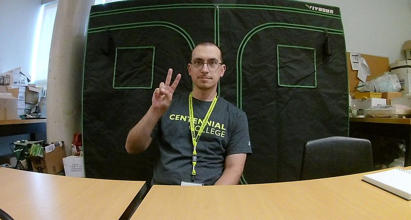 Picture of Centennial student Roman Kolomoyets who grows strawberries in his LED-equipped indoor tent